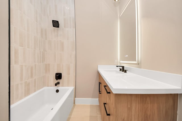 full bathroom with tile patterned flooring, vanity, baseboards, and shower / bath combination