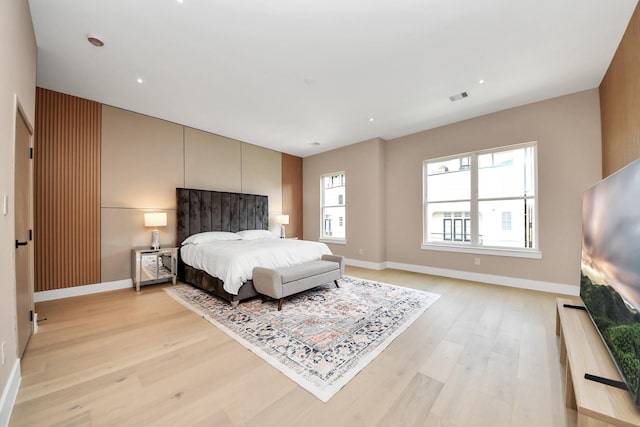 bedroom with light wood-style floors and baseboards