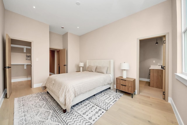 bedroom with light wood-style floors and baseboards
