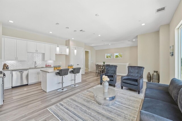 238 Julia St Unit E, Houston, TX 77022 - living area with light wood finished floors and recessed lighting