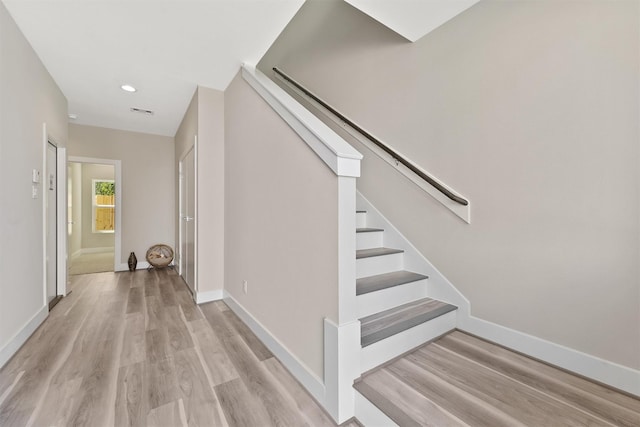 238 Julia St Unit E, Houston, TX 77022 - staircase with wood finished floors, baseboards, and recessed lighting
