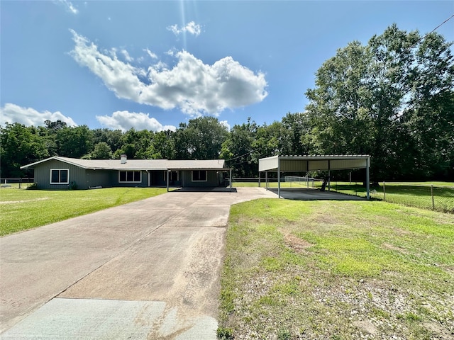 3605 Lawn Oak Dr, Orange, TX 77632 - view of front facade featuring concrete driveway, a carport, and view of scattered trees