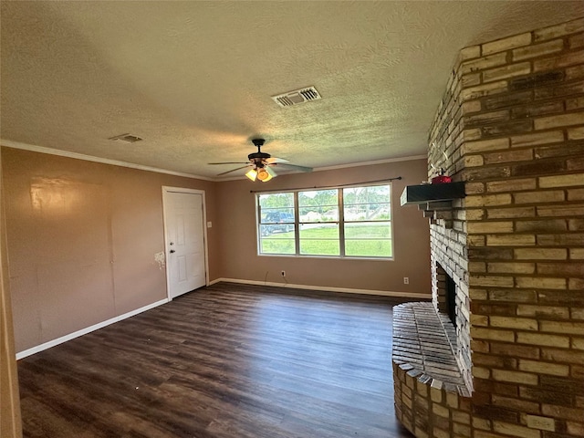 3605 Lawn Oak Dr, Orange, TX 77632 - unfurnished living room with a ceiling fan, dark wood finished floors, a brick fireplace, baseboards, and a textured ceiling