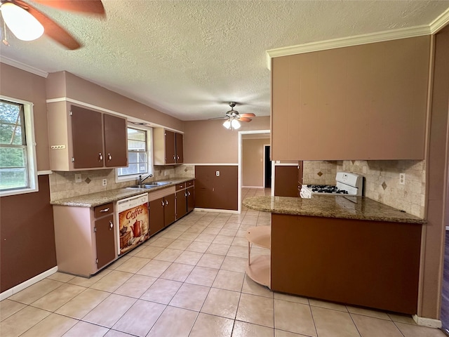 3605 Lawn Oak Dr, Orange, TX 77632 - kitchen with ceiling fan, white appliances, a sink, decorative backsplash, and light tile patterned floors