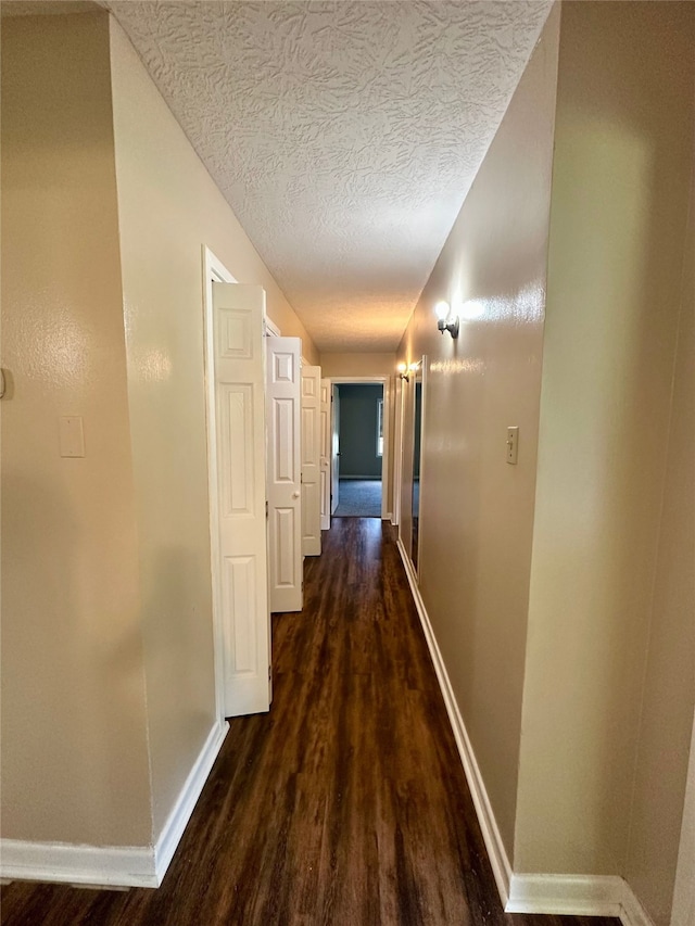 3605 Lawn Oak Dr, Orange, TX 77632 - hallway featuring wood finished floors, baseboards, and a textured ceiling