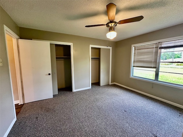 3605 Lawn Oak Dr, Orange, TX 77632 - unfurnished bedroom featuring multiple closets, carpet floors, baseboards, a textured ceiling, and a ceiling fan