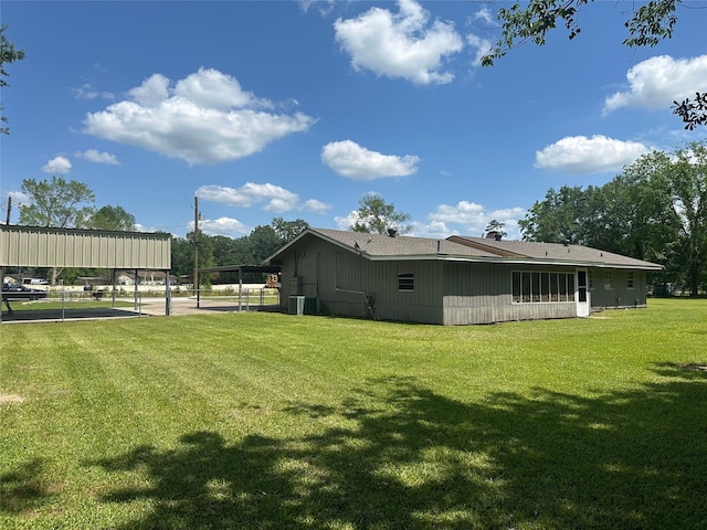 3605 Lawn Oak Dr, Orange, TX 77632 - view of property exterior with a yard, a carport, and central AC