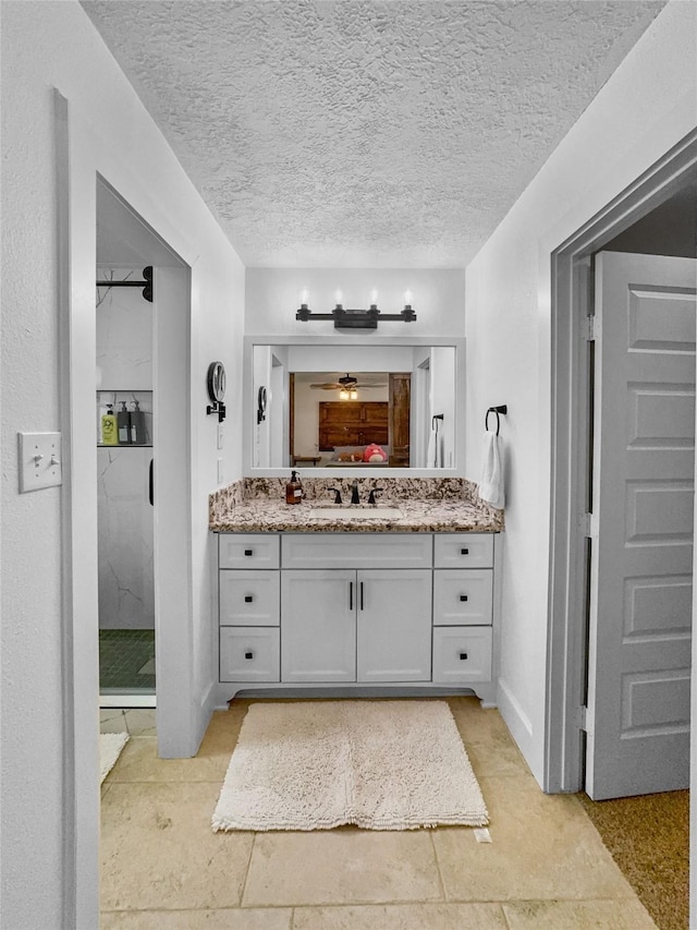 13537 Laramie Trl, Montgomery, TX 77316 - ensuite bathroom with vanity, a textured ceiling, and a shower