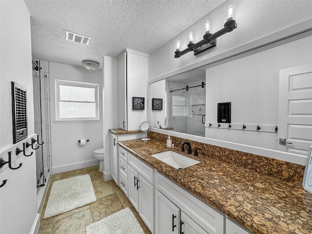 13537 Laramie Trl, Montgomery, TX 77316 - full bathroom with a stall shower, toilet, vanity, baseboards, and a textured ceiling