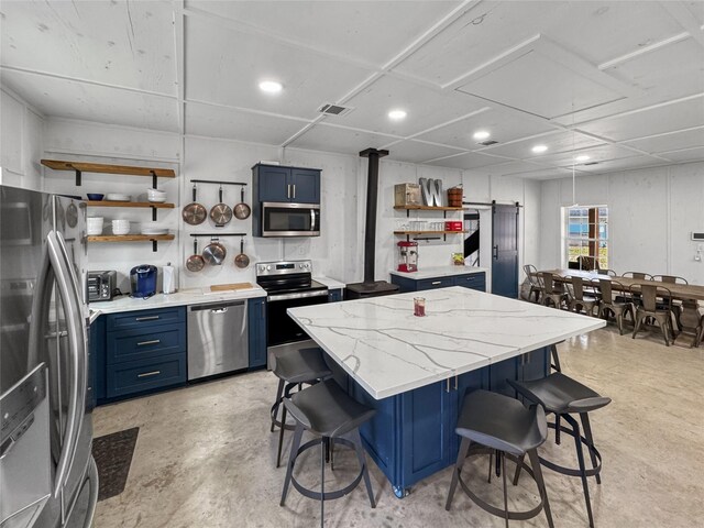 13537 Laramie Trl, Montgomery, TX 77316 - kitchen with open shelves, stainless steel appliances, blue cabinetry, a kitchen breakfast bar, and recessed lighting