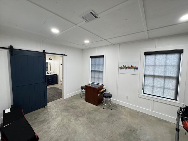 13537 Laramie Trl, Montgomery, TX 77316 - misc room featuring a barn door, concrete floors, and recessed lighting
