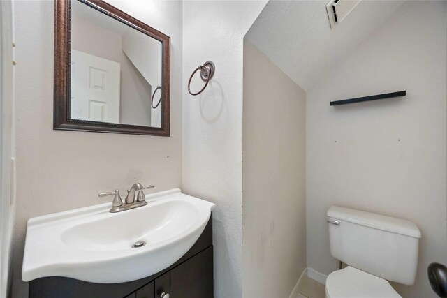 17610 Mill Springs Dr, Spring, TX 77379 - bathroom featuring toilet, vanity, vaulted ceiling, and baseboards