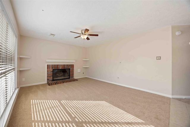17610 Mill Springs Dr, Spring, TX 77379 - unfurnished living room with ceiling fan, a fireplace, baseboards, carpet floors, and a textured ceiling