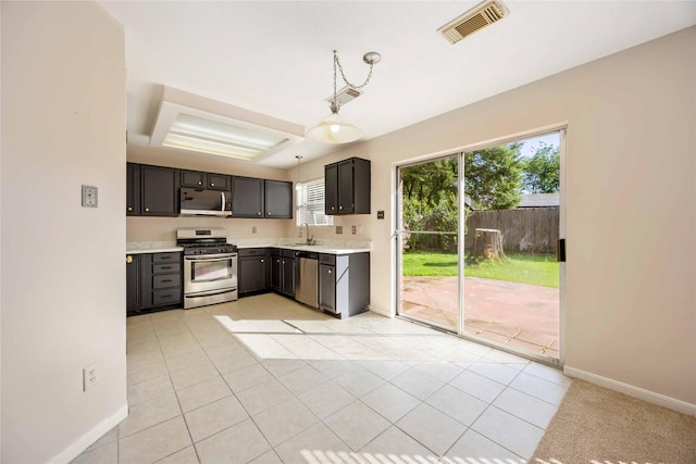 17610 Mill Springs Dr, Spring, TX 77379 - kitchen featuring appliances with stainless steel finishes, a sink, light countertops, light tile patterned flooring, and baseboards