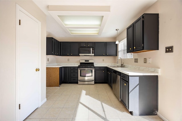 17610 Mill Springs Dr, Spring, TX 77379 - kitchen featuring appliances with stainless steel finishes, a sink, light tile patterned floors, light countertops, and baseboards