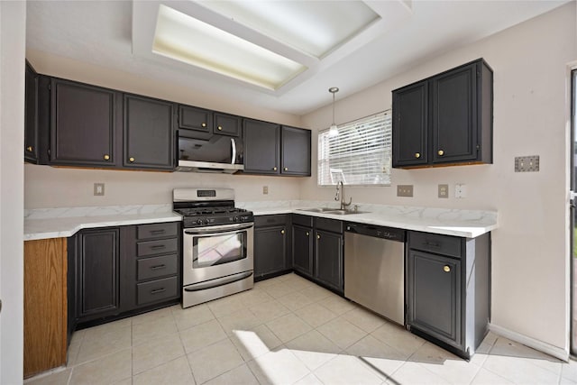 17610 Mill Springs Dr, Spring, TX 77379 - kitchen with stainless steel appliances, a sink, light tile patterned floors, and pendant lighting