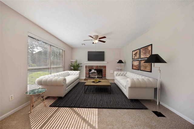 17610 Mill Springs Dr, Spring, TX 77379 - carpeted living room featuring ceiling fan, baseboards, a fireplace, and a textured ceiling