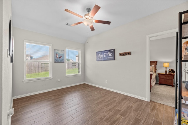 20122 Matador Ridge Dr, Cypress, TX 77433 - empty room with ceiling fan, wood finished floors, baseboards, and lofted ceiling