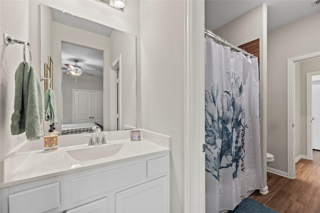 20122 Matador Ridge Dr, Cypress, TX 77433 - full bath with wood finished floors, ceiling fan, toilet, vanity, and a shower with shower curtain