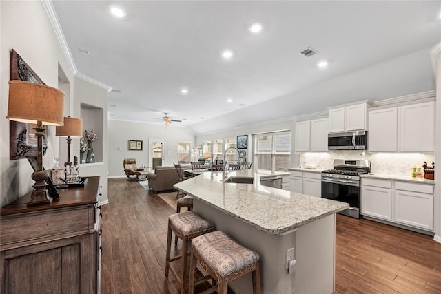 20122 Matador Ridge Dr, Cypress, TX 77433 - kitchen with stainless steel appliances, a sink, ceiling fan, decorative backsplash, and white cabinetry