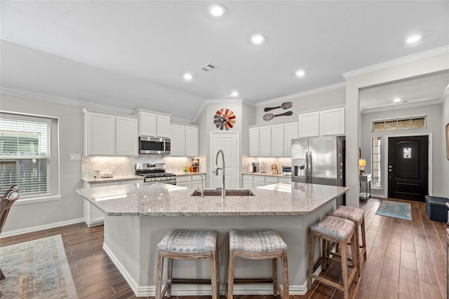 20122 Matador Ridge Dr, Cypress, TX 77433 - kitchen with stainless steel appliances, a sink, a spacious island, dark wood-type flooring, and tasteful backsplash