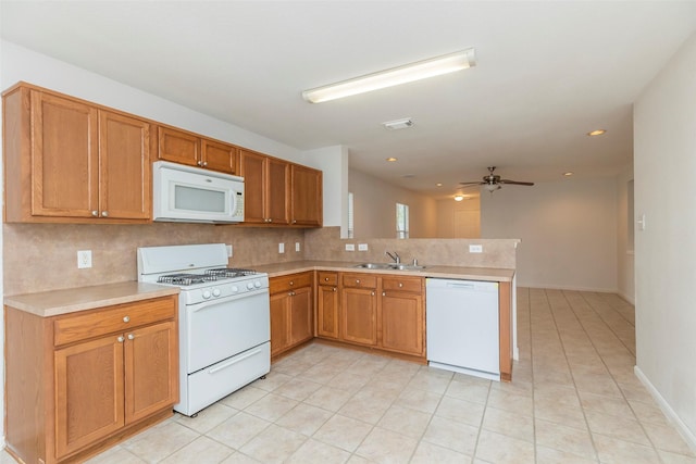 21202 Fire Wind Ct, Spring, TX 77379 - kitchen featuring white appliances, a sink, a peninsula, a ceiling fan, and light countertops