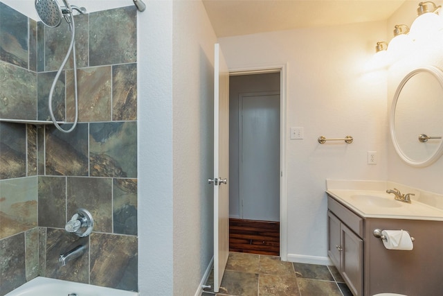 21202 Fire Wind Ct, Spring, TX 77379 - bathroom featuring vanity, baseboards, shower / bath combination, and stone finish floors