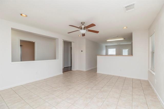 21202 Fire Wind Ct, Spring, TX 77379 - spare room with a ceiling fan, recessed lighting, light tile patterned flooring, and baseboards