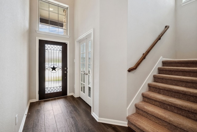 237 Catoti Cay Ct, Conroe, TX 77304 - foyer featuring plenty of natural light, dark wood finished floors, stairway, baseboards, and a high ceiling