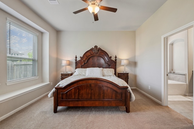 237 Catoti Cay Ct, Conroe, TX 77304 - bedroom with light colored carpet, baseboards, a ceiling fan, and ensuite bath