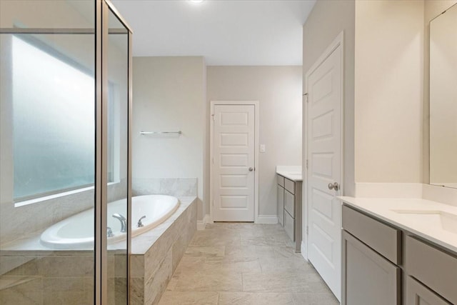 bathroom with vanity, a garden tub, and an enclosed shower
