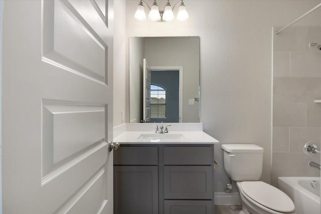 bathroom with toilet, vanity, and bathing tub / shower combination