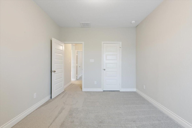 unfurnished bedroom featuring carpet floors and baseboards