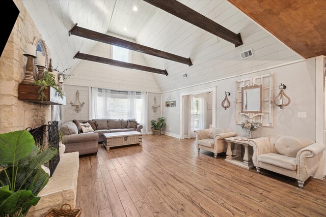 41103 Mill Creek Rd, Magnolia, TX 77354 - living area with hardwood / wood-style floors, wood ceiling with exposed beams, a stone fireplace, and high vaulted ceiling