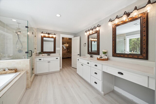 41103 Mill Creek Rd, Magnolia, TX 77354 - full bath with vanity, a shower stall, a bath, wood finished floors, and recessed lighting