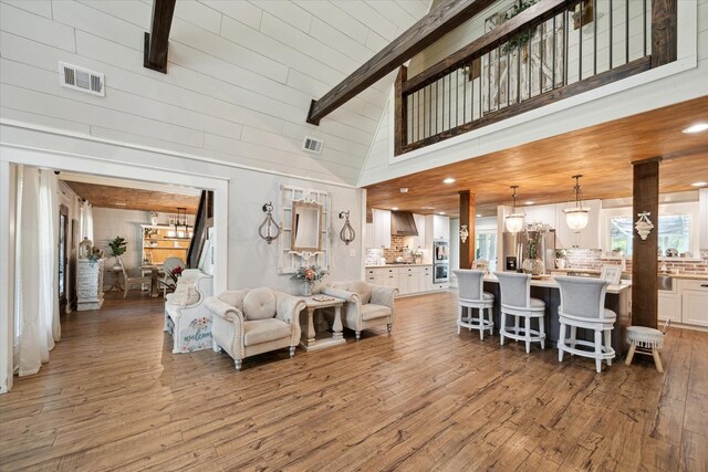 41103 Mill Creek Rd, Magnolia, TX 77354 - living area with light wood-type flooring, beam ceiling, and high vaulted ceiling