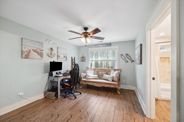 41103 Mill Creek Rd, Magnolia, TX 77354 - office area featuring light wood finished floors, a ceiling fan, and baseboards