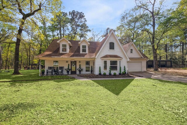 41103 Mill Creek Rd, Magnolia, TX 77354 - view of front of house with asphalt driveway, a porch, a front yard, roof with shingles, and a garage