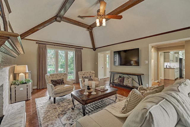 living area featuring baseboards, a ceiling fan, beam ceiling, wood finished floors, and high vaulted ceiling