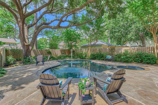 view of swimming pool with a fenced backyard, an in-ground hot tub, and a patio area