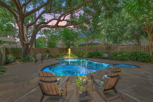 view of swimming pool with a fenced backyard and a patio area
