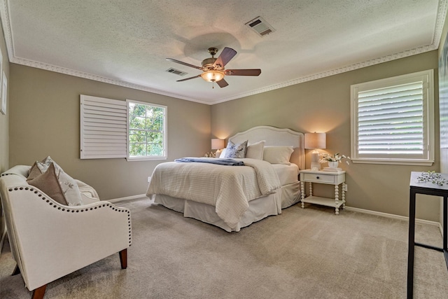 bedroom featuring baseboards, carpet floors, a textured ceiling, ornamental molding, and ceiling fan
