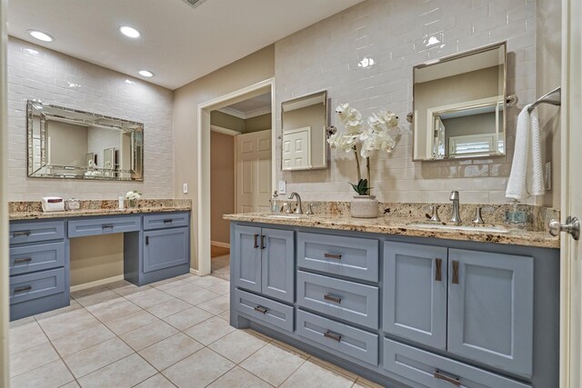 bathroom with tile patterned flooring, backsplash, double vanity, recessed lighting, and baseboards