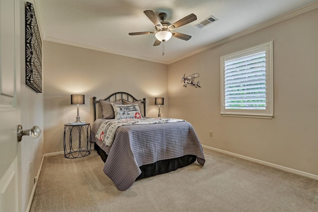 carpeted bedroom with baseboards, crown molding, and ceiling fan