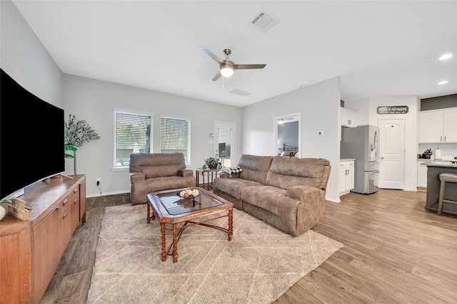 living area with light wood-style floors, ceiling fan, baseboards, and recessed lighting