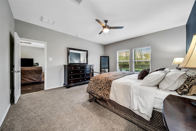 carpeted bedroom with baseboards and a ceiling fan