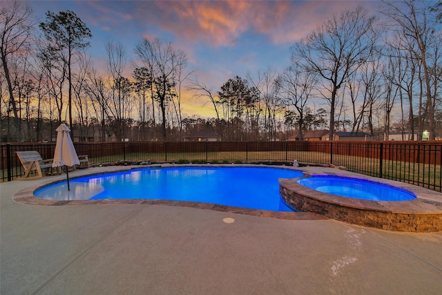 view of swimming pool with a patio area, a fenced backyard, and a pool with connected hot tub