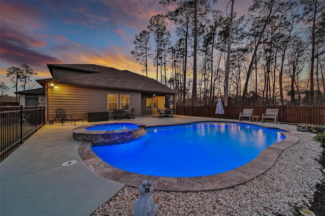 view of pool with a patio, a fenced backyard, and a pool with connected hot tub