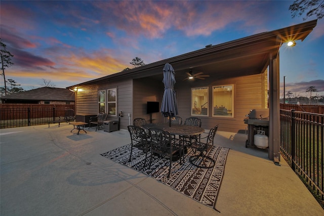 rear view of property with fence, a patio area, ceiling fan, and outdoor dining space