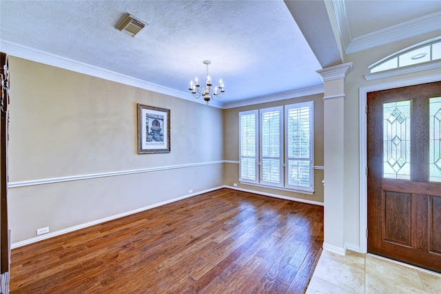 14022 Ashland Landing Dr, Cypress, TX 77429 - entrance foyer with a chandelier, wood finished floors, baseboards, ornamental molding, and ornate columns